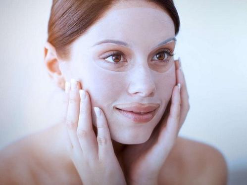 woman using a facial mask